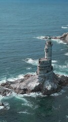 Wall Mural - Top view of rocky cape landscape and lighthouse in sea. Clip. Fabulous landscape of rocky cape of island with abandoned lighthouse. Seascape with rocky cape and lighthouse on sunny day