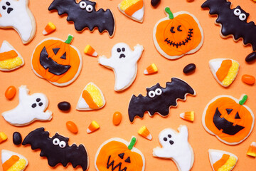 Poster - Halloween cookie background. Overhead view on an orange background with copy space. Ghosts, bats, jack o lanterns and candy corn.