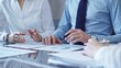 © volha_r - Business people are reviewing a financial results and discussing the terms of the agreement. Teamwork and planning
