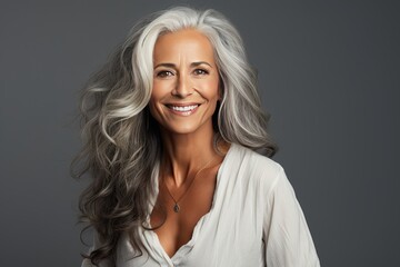 Wall Mural - Senior aging mature confident woman with long gray hair and happy smiling