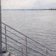 Wall Mural - gray water of Baltic Sea through cracked glass