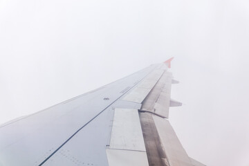 Wall Mural - View from the airplane window at a beautiful cloudy sky and the airplane wing