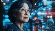 © CYBERPINK - A woman with glasses looking at a computer screen with a lot of numbers