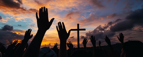 Crowd raising hands with cross at sunset: christian people worshiping god