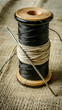 © Olive - Spool of thread with a needle. Scratch board imitation. Black and white hand drawn image.
