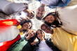 © Xavier Lorenzo - Multiracial group of young boys and girls smiling at camera standing in circle outside. Youth community and friendship concept