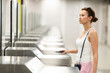 © JackF - Woman passes through a metro turnstile, paying with her smartphone. Modern technologies