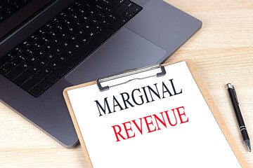 Poster - MARGINAL REVENUE text on clipboard on laptop