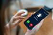 © JOURNEY STUDIO7 - Human use smartphone with incoming call from unknown number, spam, prank caller, hoax person, fake identity, scammer, scam with mobile phone, hacker, call center, crime, call, fraud or phishing.
