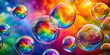 © Udomner - Rainbow soap bubbles floating on vivid colorful backdrop close up, rainbow, soap bubbles, bright, colorful, background