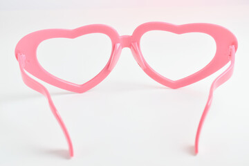 pink heart shape of glasses on white background