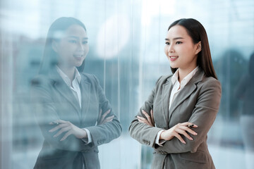 Wall Mural - A woman in a business suit is looking out a window