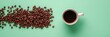 © Naru - A white cup of coffee sits on a green background, next to a scattering of coffee beans. The beans are arranged in a semi-circle, symbolizing the aroma and energy of coffee. This image is perfect for p