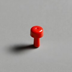 Poster - Vibrant red push pin or thumbtack placed at the center of a plain textured surface backdrop  Minimalist geometric object composition with copy space