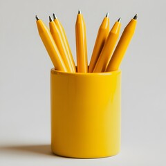 Poster - Isolated yellow pen holder placed centrally on a plain light background  The minimalist