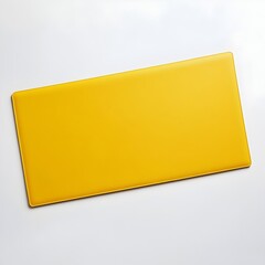 Poster - Vibrant Yellow Desk Mat Lying Flat on a Crisp White Background for a Minimalist Modern Office or Workstation Setup