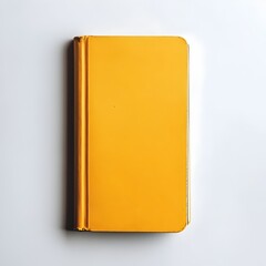 Poster - A yellow notebook laying flat at the center of a clean white surface  The simple minimalist composition showcases the stationery item in a professional organized workspace setting