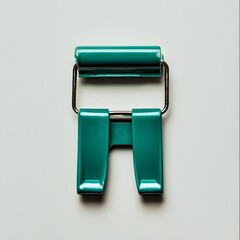 Poster - A vibrant green binder clip placed at the center of a minimalist light colored workspace setup  The simple geometric shape of the clip stands out against the clean background