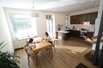 Mother and daughter eating at home