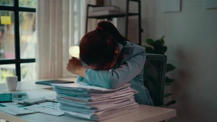Poster - Businesswoman is getting stressed while working with a lot of documents at her desk. She ends up with a headache and hides her face on the documents