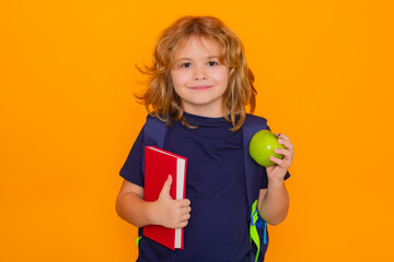 Aufkleber - School child from elementary school with book and apple isolated on yellow background. Little student, clever nerd pupil ready to study. Knowledge, education and learning.