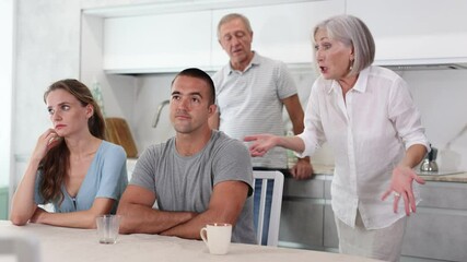 Wall Mural - Older generation, man and woman, are trying to convey their position to young people