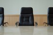 © Flowaiart - Empty Boardroom with Three Black Leather Chairs and Wooden Background in a Minimalistic Setting