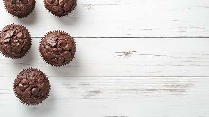 Closeup of muffins on white wood.