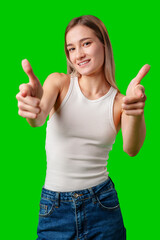 Wall Mural - Young Woman Pointing With Both Hands in Front of Green Screen