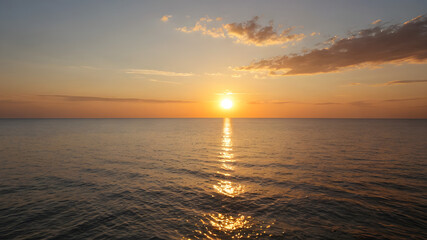 Wall Mural - Golden sunset over a calm sea, clear weather, warm glow on the horizon
