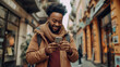 © PrabhjitSingh - Outdoor portrait of a young man engaging with his smartphone in a busy city, symbolizing the seamless experience of 5G digital communication
