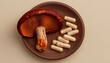 © StellaPattaya - reishi mushroom tablets capsules. trending superfood with health benefits, Traditional Chinese Medicine mushrooms on wooden podium, dietary supplement banner for sale