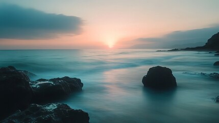 Wall Mural - A serene seascape unfolds in the soft light of sunrise, captured with a slow shutter to blur the motion of the waves.