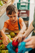© Westend61 - Son helping mother in buying apples at fruit stall