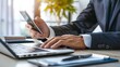 © JINGWEN - Professional businessperson using smartphone at modern desk with blurred screen close-up, hands in business attire, bright and high-definition image.