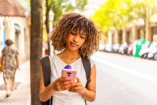 Woman using phone standing in the street