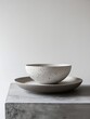 © Di - Minimalist Designer Composition Featuring a Bowl and Plate, with White Background, Embodying the Essence of Minimalist Aesthetics