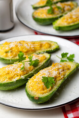 Canvas Print - Close-up of Baked Zucchini boats stuffed with ricotta cheese and tuna fish, parmesan cheese. Vertical image.