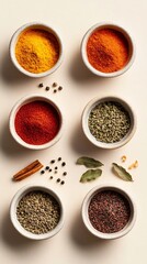 a colorful array of spices in small bowls, with a light solid color background