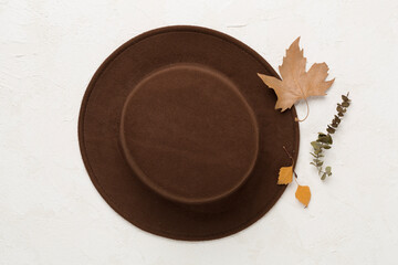 Wall Mural - Brown autumn hat on concrete background, top view