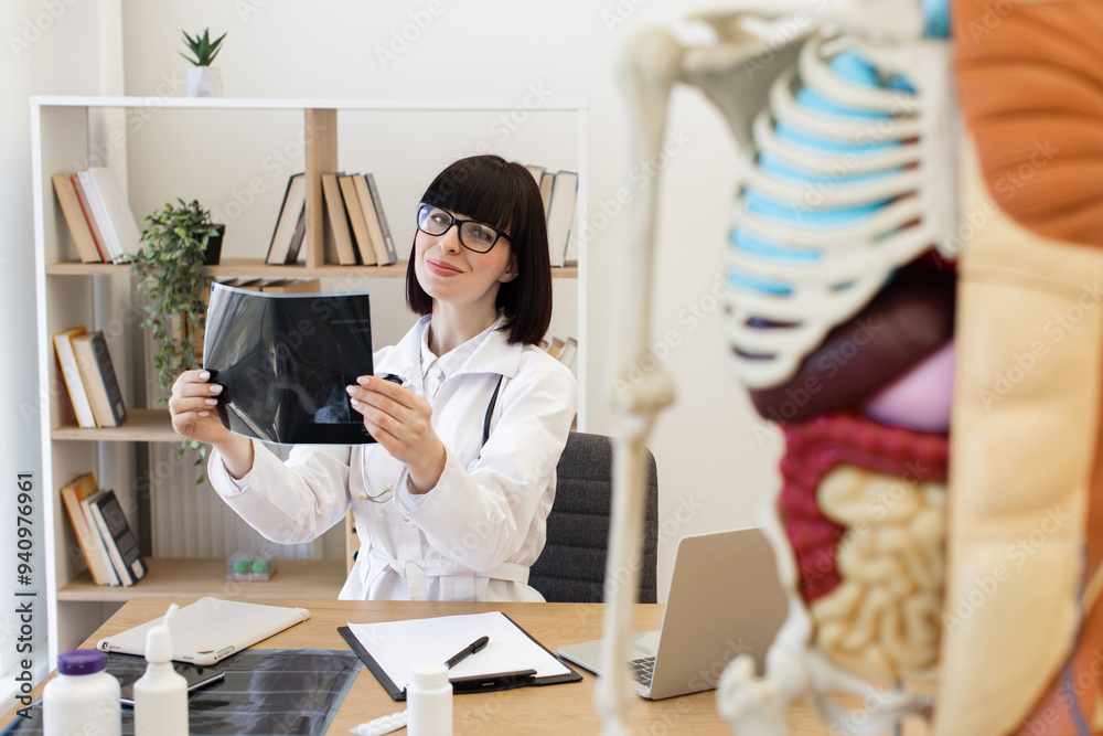 Female doctor analyzing X-ray in modern medical office. Medical ...