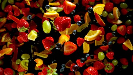 Fototapete - Super Slow Motion of Flying Fruit Up in the Air, Top View. Filmed on High Speed Cinema Camera, 1000 fps. Isolated on Black Background.
