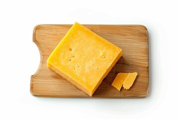 a rectangular piece of cheddar cheese on a board on a white background, top view