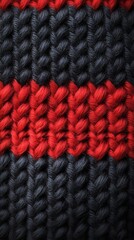 Wall Mural - A close up of a knitted sweater with red and black stripes