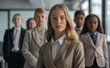 © Surachetsh - Young Girl in professional attire standing in an office, looking confident. Their serious expressions and the modern setting reflect their focus on future success and leadership.