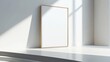 © Phatharaporn - Empty Frame on White Wall With Sunlight.