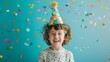 © VK Studio - A joyful child with curly hair wears a party hat and is surrounded by colorful confetti, embodying the essence of celebration and happiness.