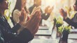 © VK Studio - A group of people clapping in a sunlit conference room, their laptops on the table, celebrating a successful presentation or meeting conclusion.