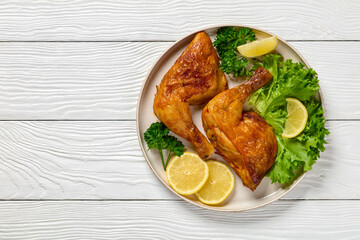 Canvas Print - fried chicken legs with lettuce, lemon on plate