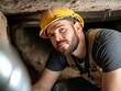 © ItziesDesign - Plumber under a house, navigating a crawl space to fix a pipe leak, with limited light and tight quarters